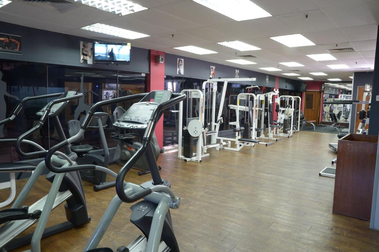 Seri Pacific Hotel Kuala Lumpur Exterior photo The photo shows a gym interior with various exercise equipment. There are several cardio machines, such as treadmills and elliptical trainers, prominently placed in the foreground. In the background, there are strength training machines lined up, ind